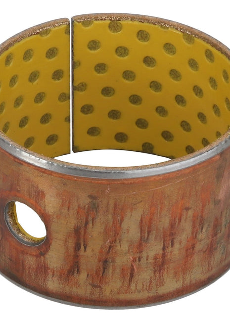 Currently, no product information is available for the AGCO BUSH - AL60004007, a bronze cylindrical bushing with a yellow inner lining and perforations, featuring a single visible hole on the side.