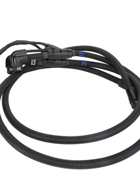 The AGCO Def Hose - Acp0432570 is a coiled black electrical wiring harness with connectors at both ends, featuring black corrugated tubing for protection and blue labels indicating components.