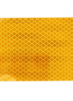 Introducing the AGCO Amber Reflector (8025777) - a yellow rectangular safety sticker featuring a honeycomb pattern for enhanced visibility.