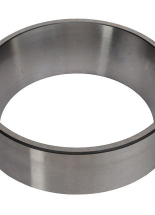 A metal cylindrical ring viewed from an angle, showcasing its smooth and polished surface, reminiscent of the robust AGCO | BEARING CUP - AG721070 used to handle thrust loads in the off-road industry.