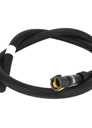 Introducing the AGCO Fuel Hose - Acw0701950, a sleek, coiled black braided cable equipped with connectors on both ends, featuring a sturdy black socket and a distinctive yellow-tipped plug.