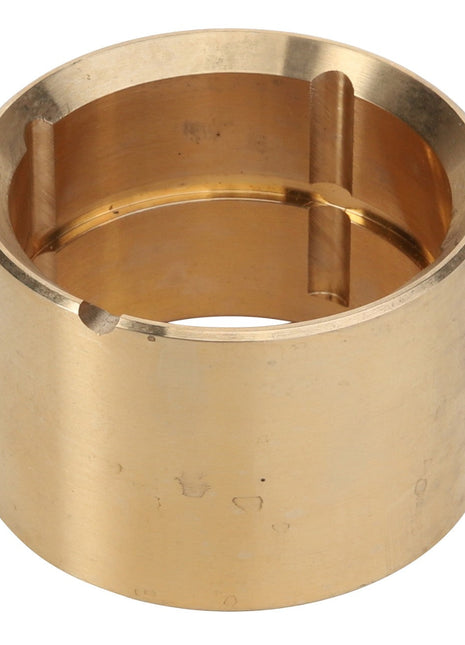 The AGCO brass cylindrical collar, product code D49066900 from AGCO, features three evenly spaced vertical grooves on the interior and a single small notch on the outer edge. No additional product description information is currently available.