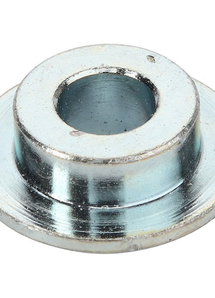 The AGCO | BUSH - D49073400 by AGCO is a metal spacer featuring a central hole and a wider base, commonly used in mechanical assemblies for aligning or spacing components.