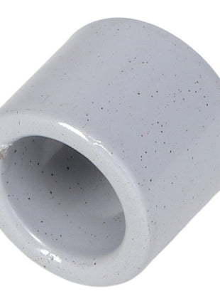 Close-up of the AGCO | SPACER TUBE - AG109812, a white cylindrical ceramic piece with an open center and speckled surface. No current product description information is available.