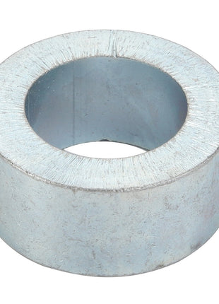 A close-up image of AGCO's Spacer - Acw1111870, showcasing its cylindrical shape, wide central hole, and likely steel construction.