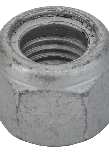 A close-up view of the AGCO | Hex Top Lock Nut - Acw8111800 showcasing its precise internal threading.