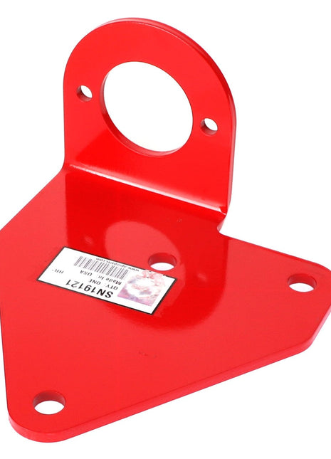 A red metal bracket, AGCO | BRACKET - SN19121, featuring three holes on the base and a large circular hole at the top with a barcode sticker displaying visible text. If you have any ordering questions, please contact our support team for further assistance.