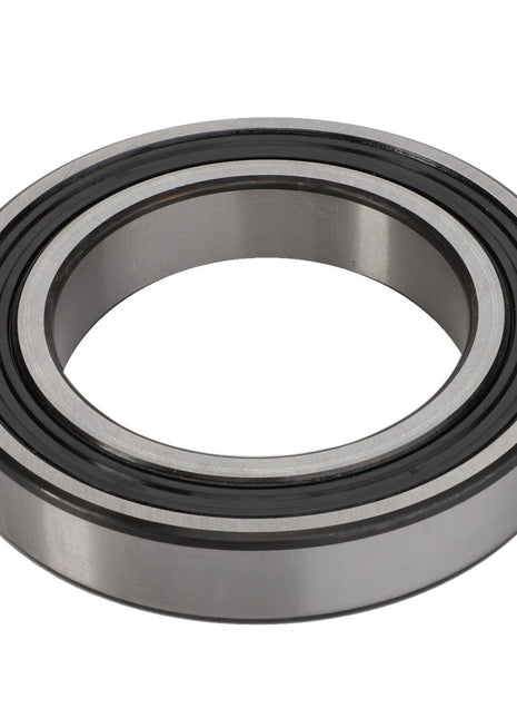 A close-up of the AGCO Bearing - La24905360, featuring a circular, donut-like shape with precisely grooved inner and outer rings.