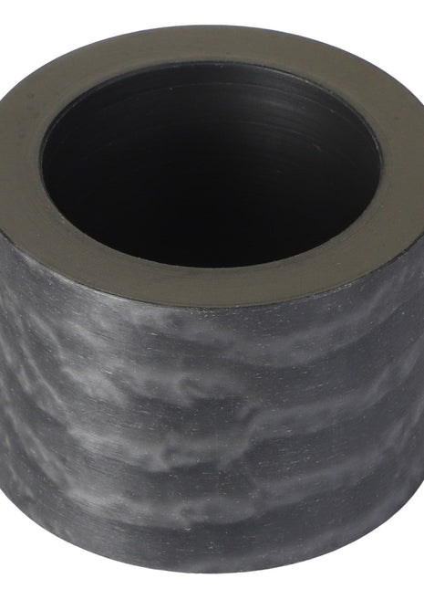 AGCO | Plastic Bushing - Acp0084550: A cylindrical black carbon fiber tube with a hollow center, exhibiting a smooth, slightly mottled surface texture. No current product description available.