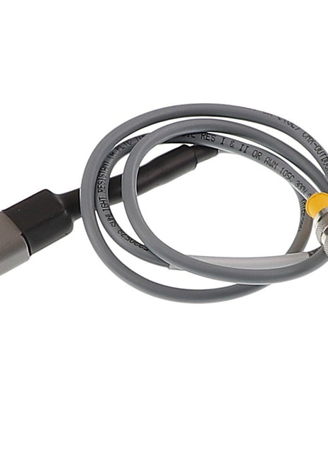 The AGCO Meter Speed Harness (Acp0008590) includes a sleek gray coiled cable with two distinct connectors: one black rectangular and the other silver circular adorned with gold contacts, ensuring a reliable and stylish connection for your devices.