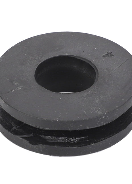 The AGCO Grommet - 6243575M1, a round black rubber component commonly used in Fendt and Massey Ferguson models, features a central hole and is displayed on a white background.