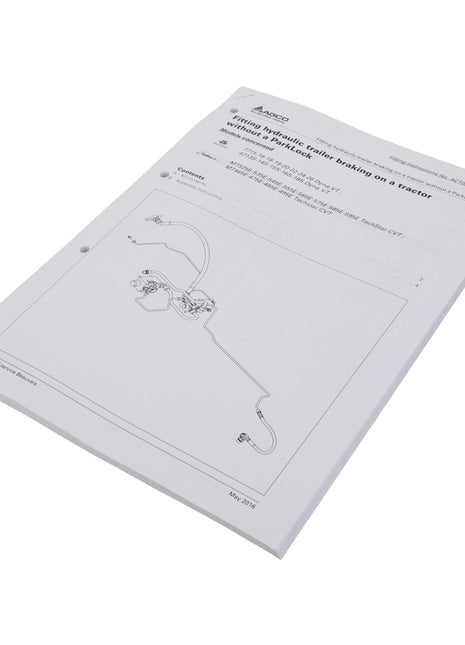 Displayed on a white surface is a bound manual titled "AGCO | Instruction Sheet - Act001337A," containing schematic diagrams and technical details for trailer braking systems. No current product description is available.