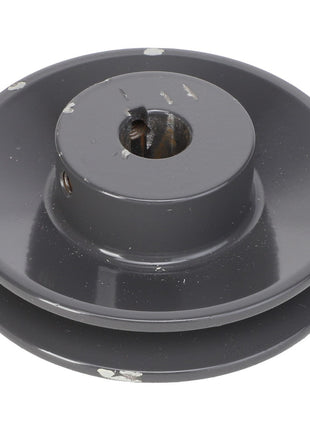 Close-up of the AGCO Sheave - Acx2767770, featuring a metallic build with a dark gray finish and minor surface wear. This sheave includes a central hole and two grooves around its circumference. Note: No current product description information is available.