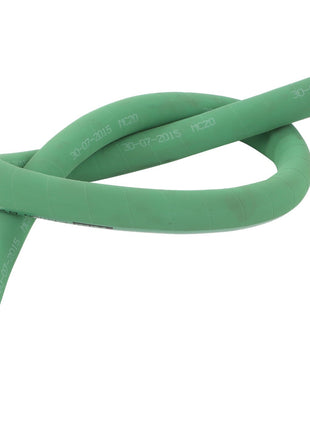 A green, flexible AGCO hose (Model D46449100) coiled loosely, with white writing indicating "30-07-2015" and "MC20" visible on its surface, lies neatly by the garden shed.