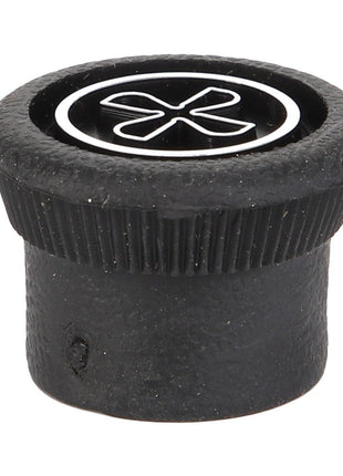 The AGCO | BUTTON - D45070026 is a black plastic bottle cap with a distinctive white flower-like imprint on the top surface, showcasing its unique design element.