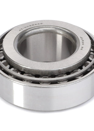 Image of the AGCO Taper Roller Bearing - F334310020060 featuring outer and inner rings, with cylindrical rolling elements arranged in a single row. Made of metallic material and designed to handle high radial loads, the bearing also has clearly visible markings.