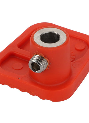 The AGCO Foot Rest - Acp0671920 is a versatile red plastic and metal fitting featuring a central threaded hole and an additional threaded side port, making it ideal for industrial or mechanical applications.