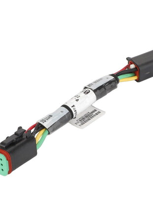 A multi-colored electrical wire harness with connectors at both ends and a label in the middle, known as the AGCO Electrical Jumper - ACW3818830 by AGCO.