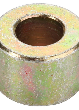 The AGCO | SPACER - D28250794 is a cylindrical metallic spacer with a large central hole, exhibiting a slightly worn, reflective surface. Additional product description information is currently unavailable.
