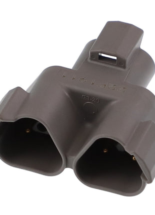 A close-up of a gray plastic AGCO | RECEPTACLE CONNECTOR - AG522411 featuring two slots and distinct ridges.