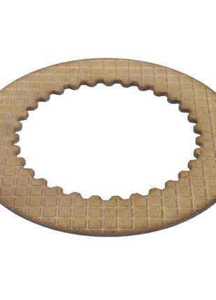 The AGCO Internal Disc - F743300021450 features a round, waffle-textured design with a large circular hole in the center and a scalloped inner edge, all precision machined to prolong service life.