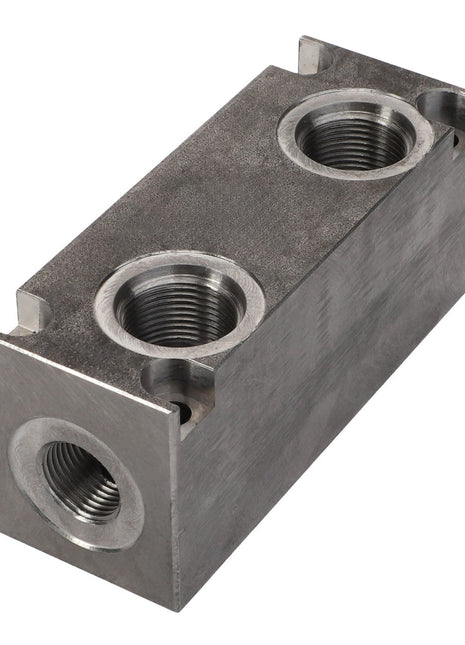 A rectangular metal hydraulic manifold block with three threaded ports and a rough surface finish, the AGCO Manifold - Acp0671210.