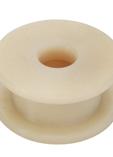 The AGCO | ROLLER - ACY1126900 by AGCO is a beige plastic spool featuring a central hole and flared edges on both sides, designed for easy use. The accompanying image shows the spool viewed from above.