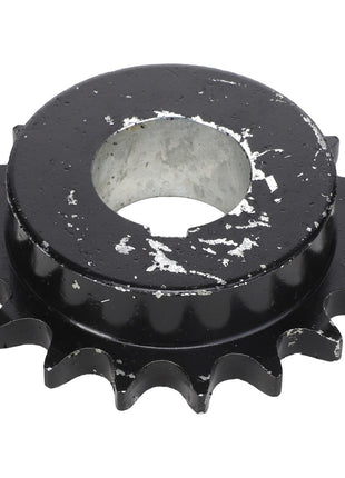 A black metal sprocket with visible wear and chipped paint, highlighted as a circular gear with evenly spaced teeth around its perimeter, matches the AGCO | Sprocket - Acx2433590 by AGCO.