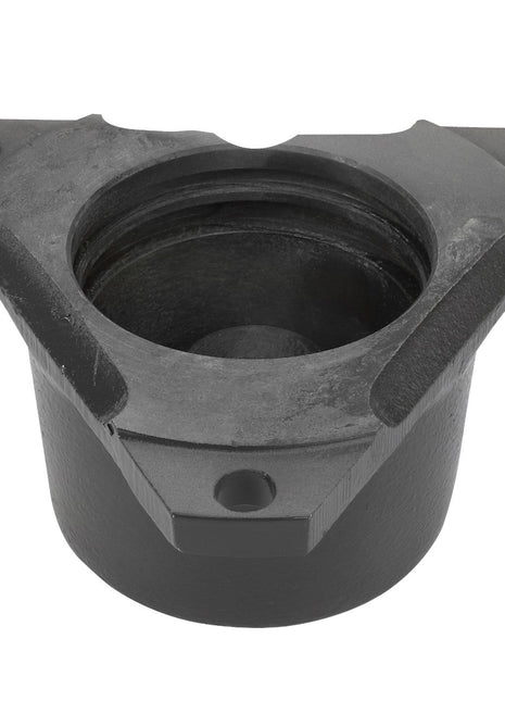 AGCO's Flange - La320655450 is a cast iron mechanical part with a cylindrical base and a triangular top, featuring three bolt holes and a central recessed cavity.
