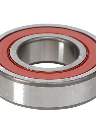 The AGCO | Ball Bearing - 1109055 by AGCO is a metal ball bearing featuring a red circular seal in the center, designed to handle both radial and axial loads.