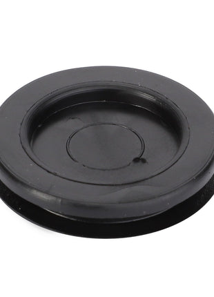 Introducing the AGCO Plug - 4289046M1, a black plastic round cover with a raised outer rim and recessed center, compatible with Massey Ferguson models.