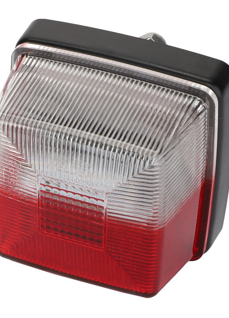 A rectangular vehicle tail light from AGCO, the Lamp - Acw1518890 model, featuring a clear upper half and a red lower half, enclosed in sleek black and chrome housing.