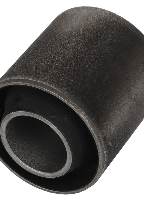 Close-up of the AGCO | Bush - Acw4387680, a cylindrical metal bushing featuring a dark, matte finish and a smooth outer surface with a central hole.