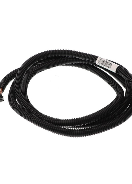 The AGCO Harness - Acx3140220 is a coiled black electrical cable that features connectors at both ends: one end has a black rectangular connector, while the other end has a notable black and green oblong connector. Currently, there is no additional product description information available.