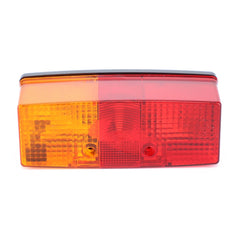 The AGCO Combination Light for the rear left side, model X830180047000, features red and amber sections with a textured lens and two visible mounting holes. Crafted from AGCO Genuine Lighting Parts for durable quality, it ensures optimal illumination and safety with 12V 21W and 12V 10W bulbs.