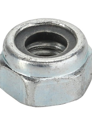 Close-up view of the AGCO | Top Lock Nut - Va022408, featuring a steel hexagonal shape with an internal threaded hole. The nut has a smooth surface and a circular opening in its center, branded by AGCO.