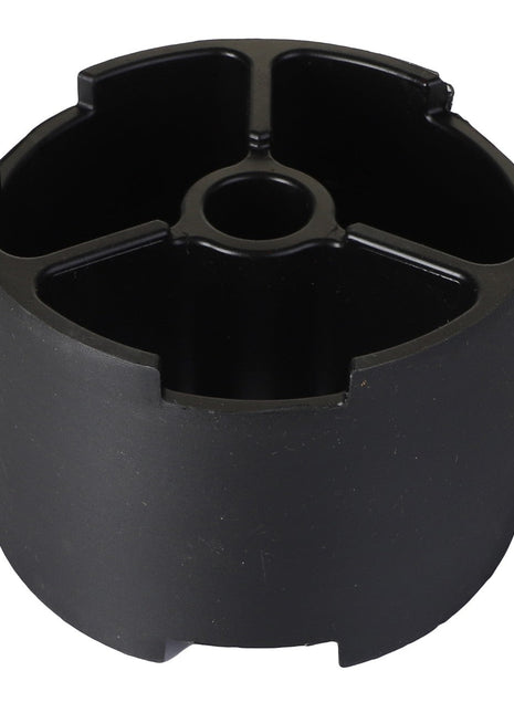 The AGCO | SPACER - ACP0131820 by AGCO is a black plastic cylindrical object featuring four inner compartments and a central hole, ideal for organizing small items. For ordering or additional information, please contact our support team.