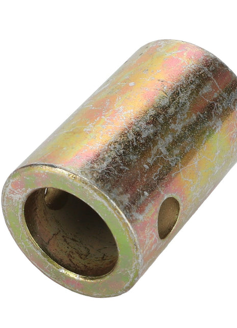 The AGCO ADAPTER - D28182364, a product by AGCO, is a cylindrical metal coupling with a yellowish, slightly rusted surface, featuring two large holes and two smaller ones. No current product description information is available.