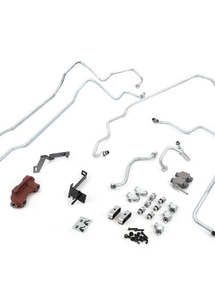 Assorted automotive parts, including metal tubes, brackets, bolts, and an AGCO Front Power Lift (Acp0673940) in red, are laid out on a white surface.
