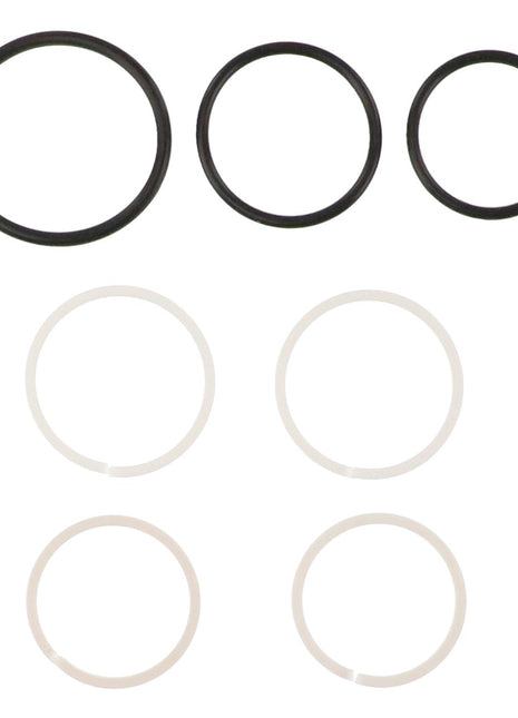 Six rubber O-rings from the AGCO SEAL KIT - AG121390 are arranged in two rows. The top row has three black O-rings in decreasing sizes from left to right, while the bottom row features three white O-rings, identical in size. No available product description information highlights the simplicity and uniformity of this design from AGCO.