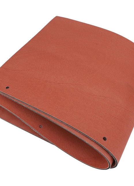 A flat, folded, vibrant orange rubber conveyor belt with small holes neatly aligned along one edge, known as AGCO | Seal - Acx2752470 by the brand AGCO.