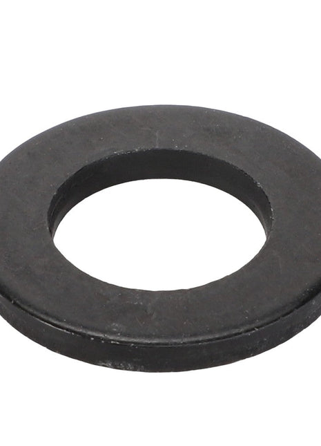 A close-up of the AGCO Flat Washer - Acw9114020, a black metal washer with a central hole, showcases this annular disc used in mechanical assemblies.