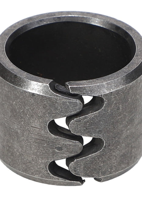 The AGCO Bearing Bush - Acp0018930 is a metal coupling with a split design, featuring serrated edges on both sides for a secure fit. No current product description available.