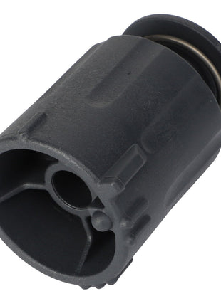 An AGCO KNOB - AL10550327 by AGCO is a cylindrical mechanical component with a dark finish, featuring a hollow interior, a central circular hole, and an outer rim with grooves.