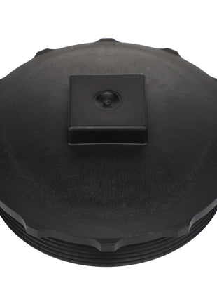 Close-up view of the AGCO Cap Fitting - Acw2407700 featuring a black plastic lid with a square knob in the center. No current product description information available.