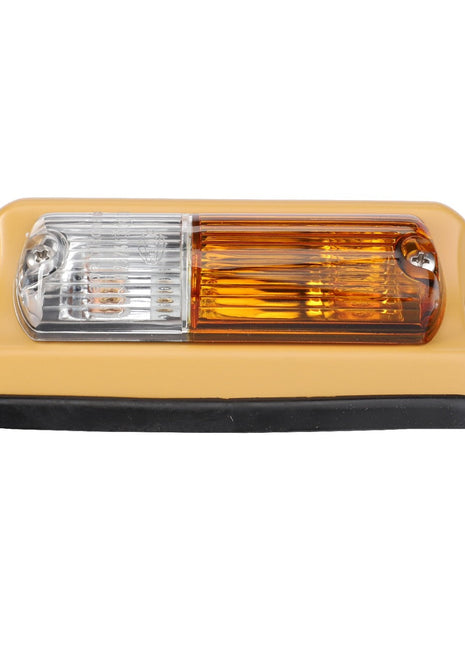 The AGCO Turn Signal Light, with product ID F228900020010, features a rectangular design with a clear lens on the left and an amber lens on the right, mounted on a beige base with rounded edges. Designed for optimum safety and reliability, this versatile light serves as both a headlight and turn signal light on the left side of your vehicle.