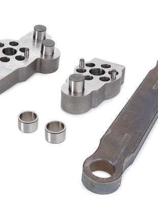 Three essential components found in AGCO tractor ranges—a multi-holed manifold, a matching cover with cylindrical elements, and a long, flat lever arm—are carefully arranged on a plain white background. These parts are part of the AGCO Repair Kit - U926103410000.