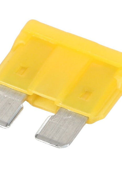 A close-up of the AGCO | FUSE 20A - AG562929, a yellow automotive blade fuse with two metal prongs.