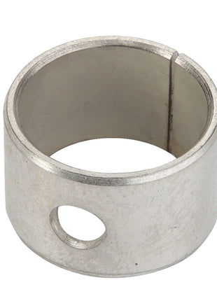 An AGCO Bearing Bushing - F100002238022, featuring a steel ring with a circular hole and a vertical slit, essential for various mechanical or industrial applications.