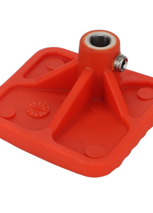 The AGCO Foot Rest (Acp0334370) is a red, square-shaped plastic object featuring a centrally located cylindrical metallic hole with a screw fitting. Currently, no detailed product description is available for this item.